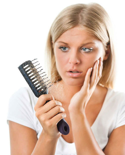 Hair additions for thinning hair picture of ladies holding hairbrush with too much hair in it